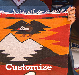 A vendor proudly displaying his tapestry at the Otavalo Market